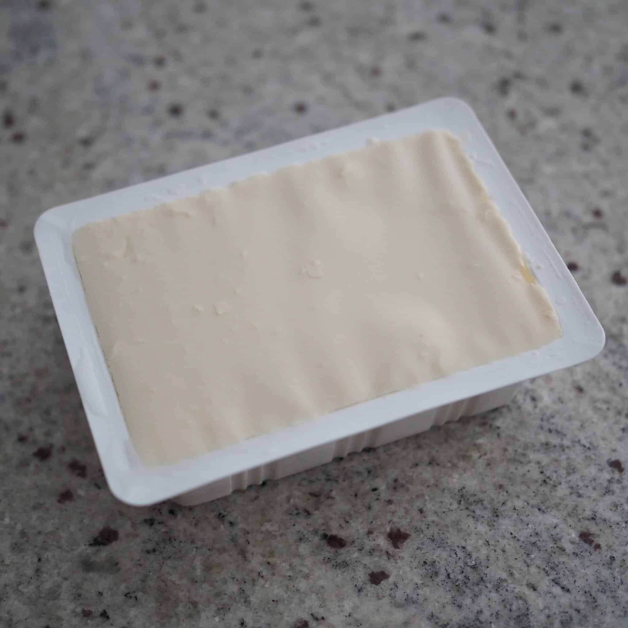 peel away plastic from soft tofu package