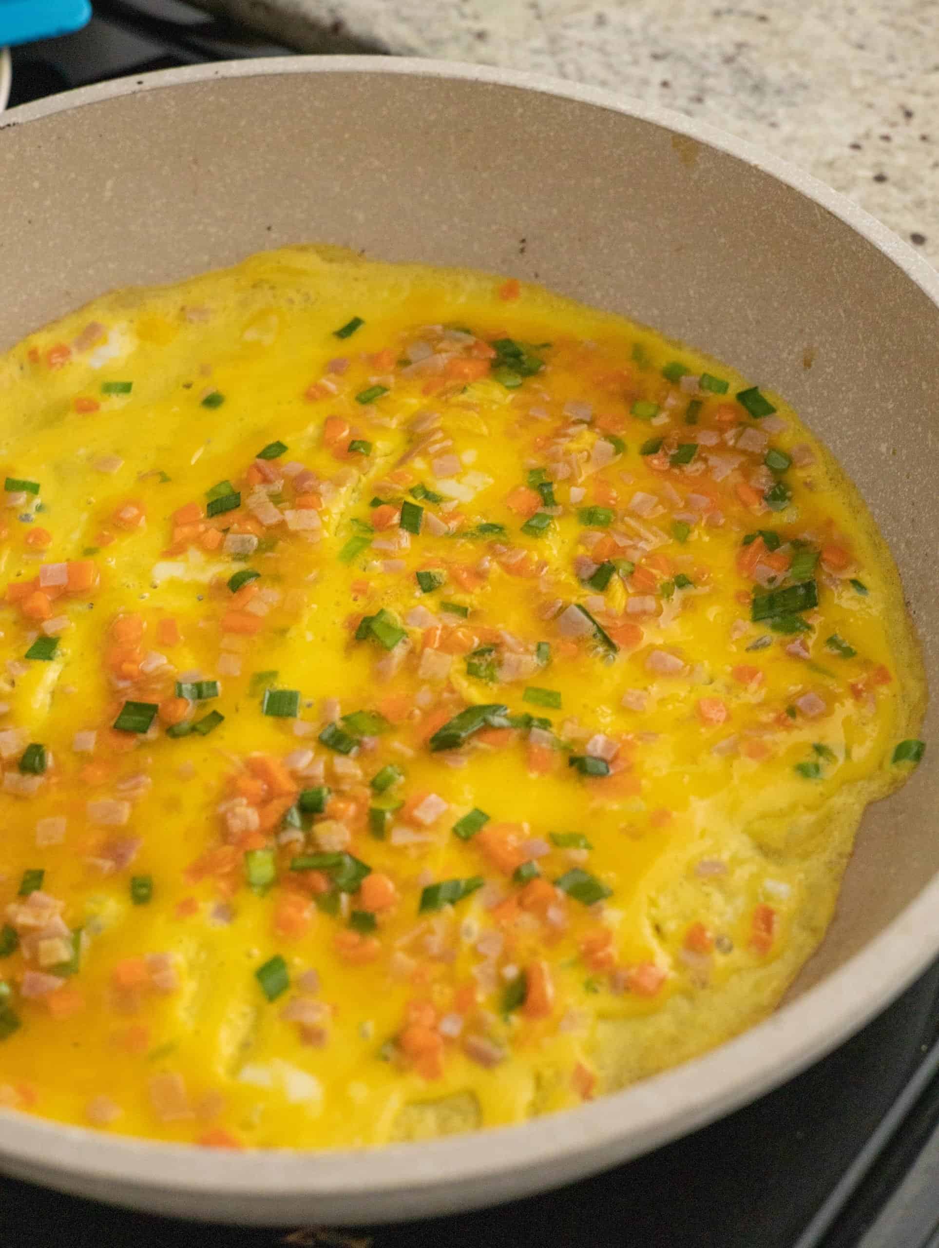pour omelette into pan
