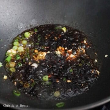 Then quickly add to the pan in this order: sesame oil, gochugaru, sugar, chicken bouillon powder, Chinese black vinegar, and both soy sauces, so the ingredients in between don't burn. 