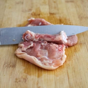 Debone the chicken thighs by carefully making small slits around the bone with a sharp knife, until it can be easily removed. If you're using boneless chicken thighs, skip this step. 