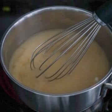 On medium heat, mix miso paste into the dashi broth until combined with a whisk to break down the paste more quickly. 