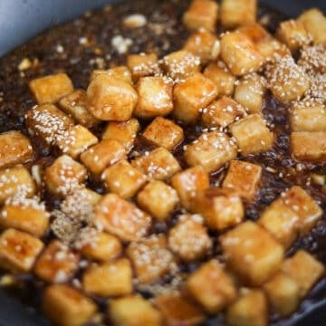 Reduce to medium-low heat. Pour in sauce and simmer to thicken. Once thick add in the fried tofu and gently toss to combine. 