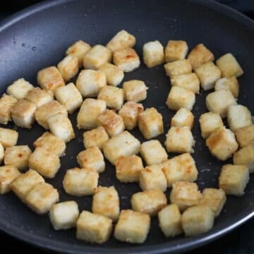 Heat vegetable oil in a large non-stick pan on medium heat. Pan fry tofu in a single layer for 20 minutes in total until golden brown, flipping over halfway. Do not constantly move the tofu or it won't become crispy. Remove and set aside. 