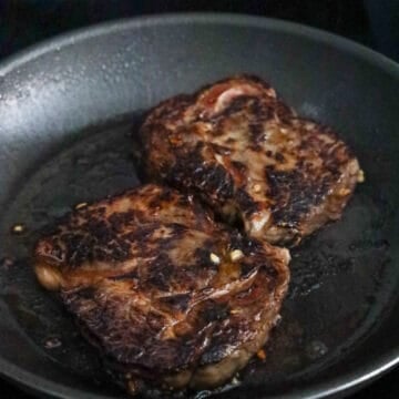 Heat vegetable oil in a heavy bottom frying pan or cast iron skillet on medium-high heat. Sear steaks on each side for 3-4 minutes for rare steak to medium rare with internal temperature of 131-139 F. For medium well, cook for another 1 minute on each side on medium-heat until you reach an internal temperature of 150-158 F.  For well done, cook for another 2-3 minutes on medium heat on each side until you reach an internal temperature of 158 - 212 F