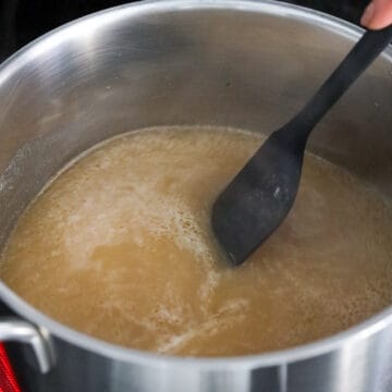 In a medium size pot, add chicken stock, soy sauce, oyster sauce, chicken bouillon powder, sesame oil, and sugar. Stir and bring to a boil on high heat. 