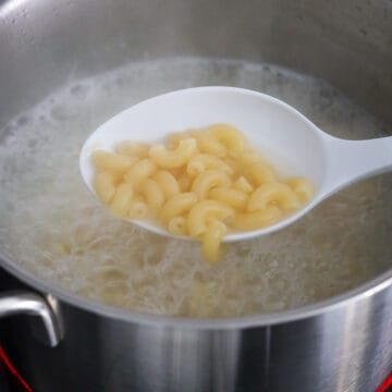 In a medium size pot filled with 7 cups or 1.65 liters water, add 1 tablespoon salt. Bring to a boil on medium-high heat and add macaroni pasta. Boil pasta according to package directions, about 11 minutes on high heat for Al dente or 13 minutes for slightly overcooked (like in authentic HK style macaroni soup).