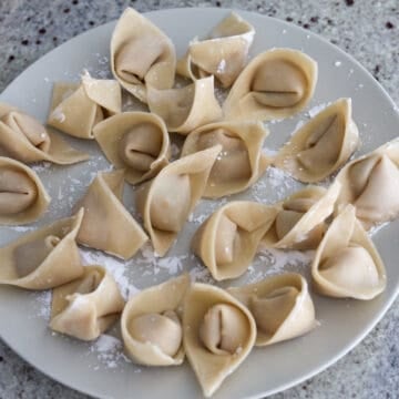 Place assembled wontons on a baking sheet with parchment paper or excess cornstarch to prevent them from sticking. (With the leftover filling, shape into little patties or meatballs and fry in a large pan with some oil over medium heat until cooked through). 