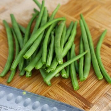 Wash and trim the pointy hard ends of green beans. Optional: feel free to chop them into smaller segments.  