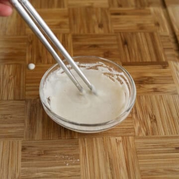 In a separate small bowl, combine all-purpose flour and cold water. This will be your egg roll wrapper “glue”.