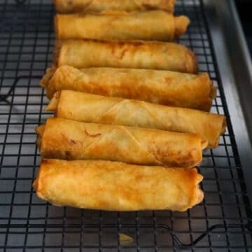 Transfer fried egg rolls onto a wired rack or paper towel lined baking sheet so excess oil can drip off.