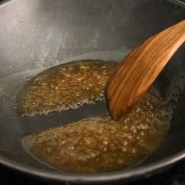 Reduce to medium heat, pour in the prepared gravy sauce into the pan and simmer to thicken, about 1 minute.  