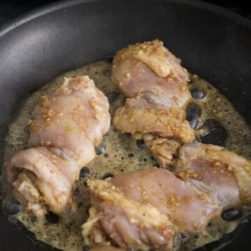 Heat 1 tablespoon vegetable oil in a large non-stick pan on medium-high heat. Remove chicken from the marinade shaking off any excess marinade. Fry chicken in small batches in a single layer giving each piece enough space. Cook chicken on the first side for 3-4 minutes until golden brown and charred in some areas.