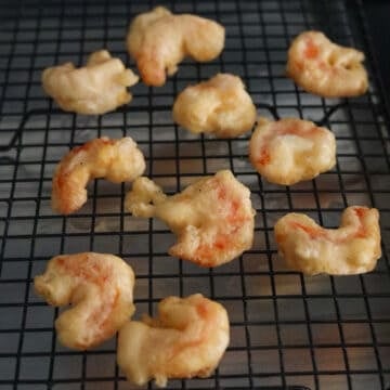 Remove shrimp from hot oil with a slotted spoon or tongs and transfer to wire rack or paper towel lined baking sheet to drain off excess oil. Excess oil creates soggy shrimp.
