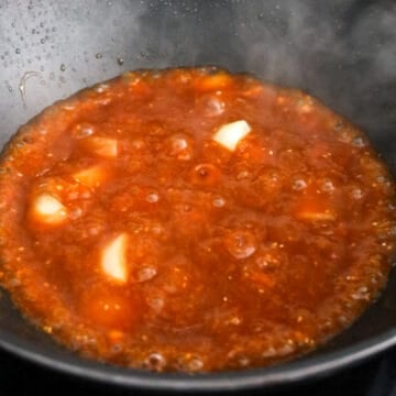 Pour in sauce to simmer to thicken. 