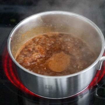Heat vegetable oil in a small saucepan on low heat. Sauté garlic for 15-20 seconds or until fragrant. Mix in hoisin sauce, peanut butter and water. Then bring to a boil on medium-high heat. 