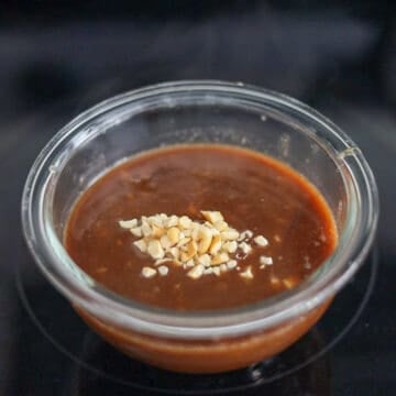 Once the sauce boils, remove off heat and transfer it to a small bowl to cool.  Sprinkle crushed peanuts on top of the sauce. Place hoisin peanut sauce in the fridge to chill. 
