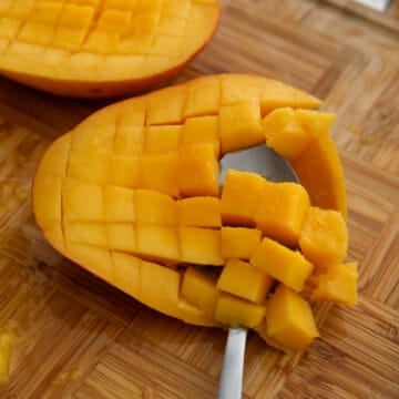 Peel the remaining mango and dice the mango flesh into 1-cm cubes. Or see expert tips on how to easily dice mango. 