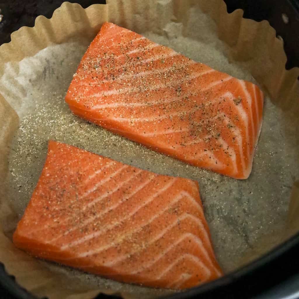 Season Salmon Fillets in Air Fryer Basket