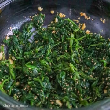 Mix spinach with sauce with clean hands or tongs