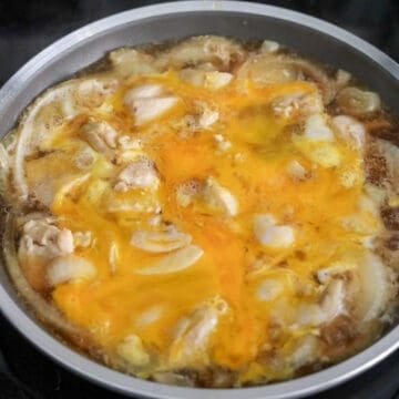 Pour beaten eggs in a circular motion on top of the chicken and cooked onions. Let this cook for 2 minutes until it’s mostly cooked but slightly runny in some areas.