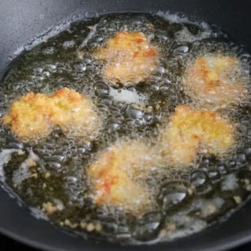 In a large heavy-bottomed pan, heat oil over medium-high heat or 350 degrees F with a digital instant read thermometer.  Deep fry shrimp in small batches (4-6 pieces per batch) for 2-3 minutes or until golden brown, flipping over halfway. Cooked shrimp has an internal temperature of 145 F.  