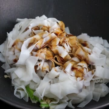 Add remaining oil and toss in rice noodles and add noodle sauce. Gently toss until noodles are coated in sauce. 
