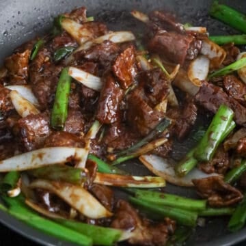 Add sauce and the onions to the beef.