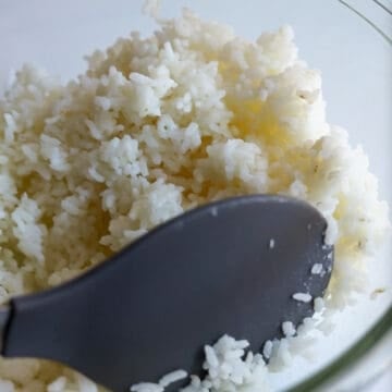 Transfer freshly cooked or warm rice to a large bowl and season with salt. Mix well. Cover with a lid and keep warm. (Or feel free to use cold day-old rice that has been stored in an airtight container and reheat it in the microwave for 1-3 minutes covered until hot). 