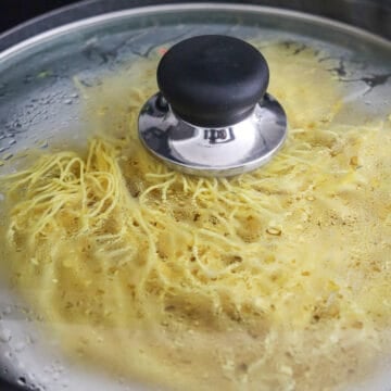 In a large wok or steamer, fill the bottom with 2.5 cups / 625 ml water. Place a small wire rack into the steamer and a plate on top. Place the chow mein noodles on top of the plate. Cover and steam the noodles over high heat for 5 minutes to reheat them. Remove the plate of noodles with oven mitts to set aside and dry out the wok of the liquids. (If you don't own a steamer, blanch the noodles for 20 seconds in hot boiling water and strain the noodles in a colander). 