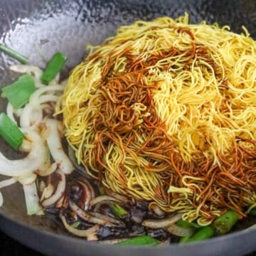 Add noodles, regular soy sauce, dark soy sauce and sesame oil and toss until noodles are evenly colored. 