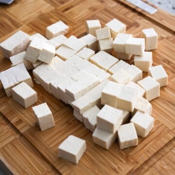 Strain the tofu block of the liquids in the packaging. Pat dry the tofu with clean paper towel to remove as much excess moisture. Slice the block of tofu into small equal sized cubes (about 1-inch cubes).