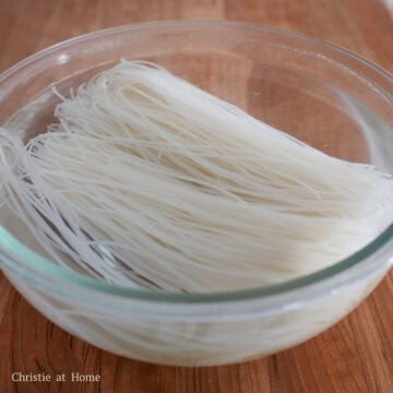 In a large bowl, soak dry rice vermicelli noodles in boiling water for 1 - 2 minutes or until limp, loosened and slightly softened. Strain the noodles and rinse off with cold running water. Shake out as much excess water as possible and set aside.