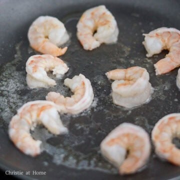 Then heat vegetable oil in a large pan on medium heat. Fry the shrimp until slightly pink and curled, about 75% cooked. Do not overcook. 