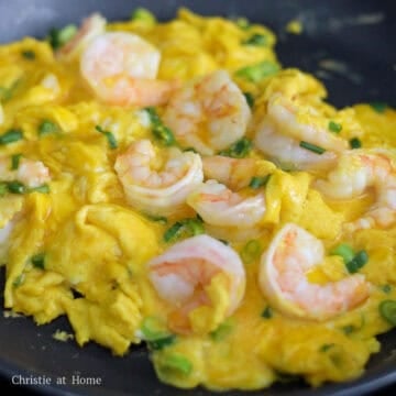 Next slowly scramble the eggs with the shrimp until the eggs are shiny, moist and cooked through. Or you can continue cook the eggs until the omelette is golden brown for extra flavor. Slice the omelette onto a large serving plate and enjoy!