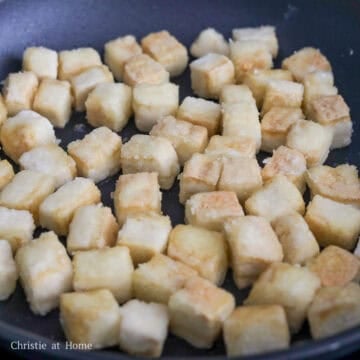 Heat vegetable oil in a large pan on medium heat. Fry coated tofu until golden and crispy, about 14-20 mins in total, flipping over halfway. Remove fried tofu from pan and set aside.