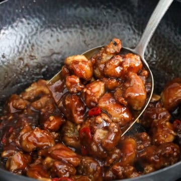 Add fried chicken and toss to coat evenly and garnish.