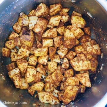 Set the Instant Pot to Sauté Mode on the highest heat setting. Sauté garlic in butter. Add potatoes and sauté for 2-3 minutes. Then toss in all the ground garam masala, ground coriander, ground cumin, paprika, ground turmeric, ginger powder and salt.