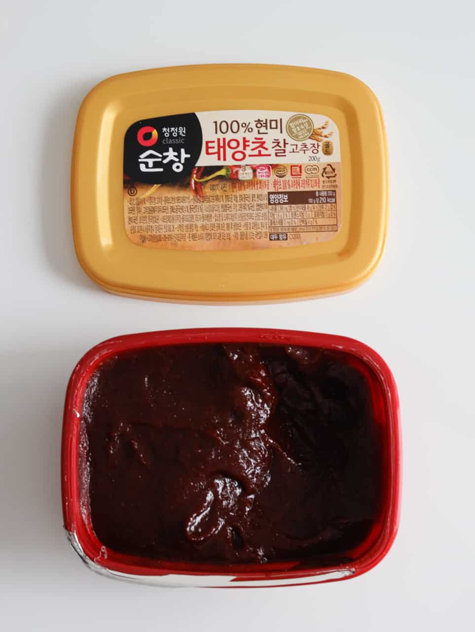 a picture of gochujang in a red tub