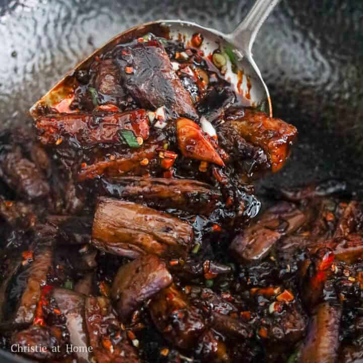 Tender eggplant pieces thoroughly coated in a thick, glistening garlic sauce.