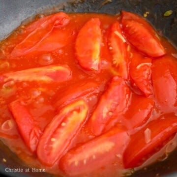 Pour the sauce mixture over tomatoes and simmer to thicken, about 1-2 minutes.