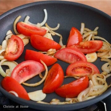 Sauté garlic and onions until slightly softened, about 1 minute. Add chopped tomatoes and fry until softened, about 2-3 minutes.