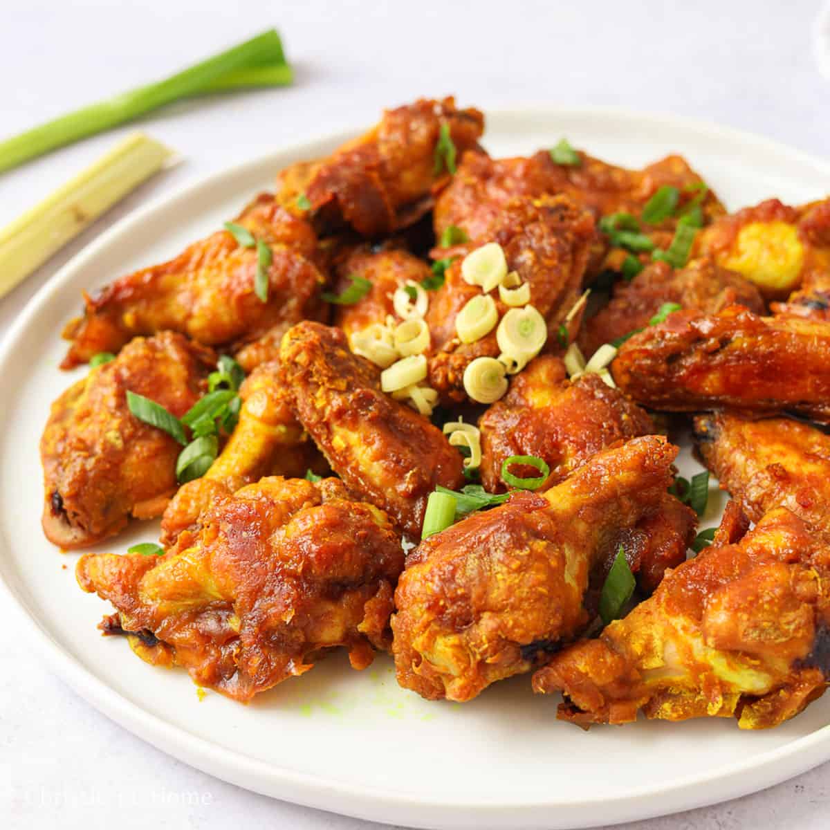 Reduce the oven temperature to 400 F and bake for a total of 35 minutes, flipping the wings at the halfway mark. Remove wings from the oven and transfer to a serving dish. Garnish with green onions. Enjoy!