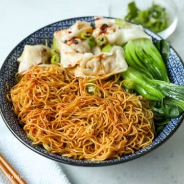 Divide the seasoned noodles between the serving bowls. Garnish with green onions and more chili oil if you wish!