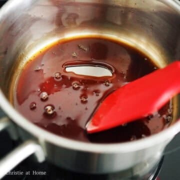 Thick, bubbling brown sugar syrup simmering in a small saucepan.