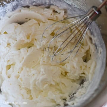 Whip heavy cream with an electric hand mixer until you have stiff peaks.