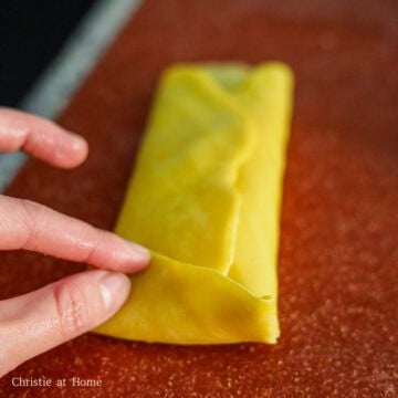Gently roll the pancake and then fold in the edges. The edges may not stick, but this is normal. Don't tightly roll the pancake or it can break.