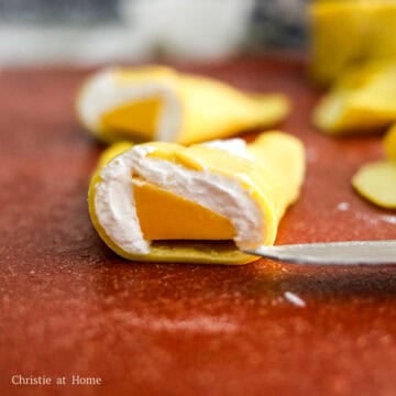 Turn the pancake over, so the edges face down and slice into half. Repeat this for the remaining pancakes until there are none left.