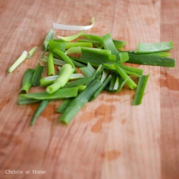 Pat dry washed scallions, split them down the middle and chop into 2-inch long pieces.