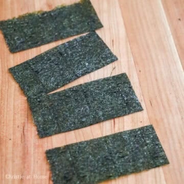 Nori sheet folded and cut into strips for spicy tuna onigiri.
