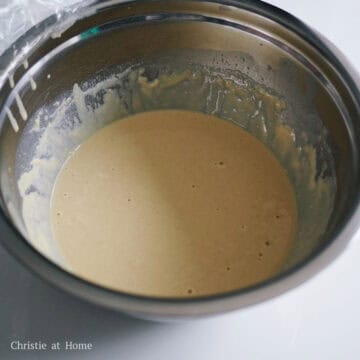 In a large mixing bowl, sift and whisk all-purpose flour, self rising flour, baking soda, and salt. Then in a medium sized bowl, whisk together warm milk, dry active yeast, vanilla extract and sugar.  Allow the yeast to dissolve completely. Whisk the milk mixture into the dry ingredients. Crack an egg into the batter and whisk just until combined and do not over mix. 